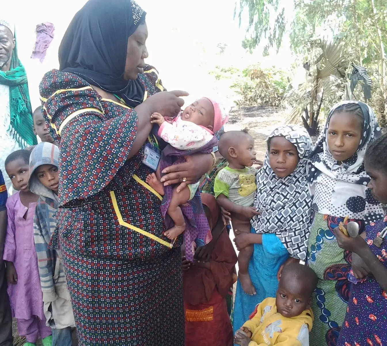 File photo from a polio campaign in Nigeria: a health worker gives a baby oral polio vaccine drops while other young children wait. Representative image of an oral polio round, not a photograph of the Hurghada campaign.