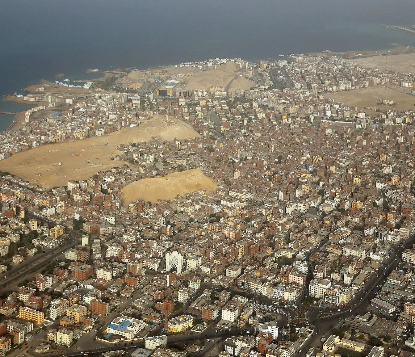 An aerial view over Hurghada, showing the city's streets and built-up blocks.