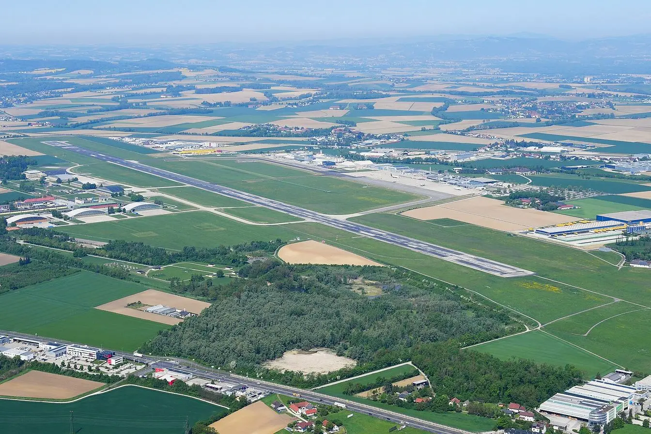 Aerial view of Linz airport in Austria, showing the runway and terminal apron