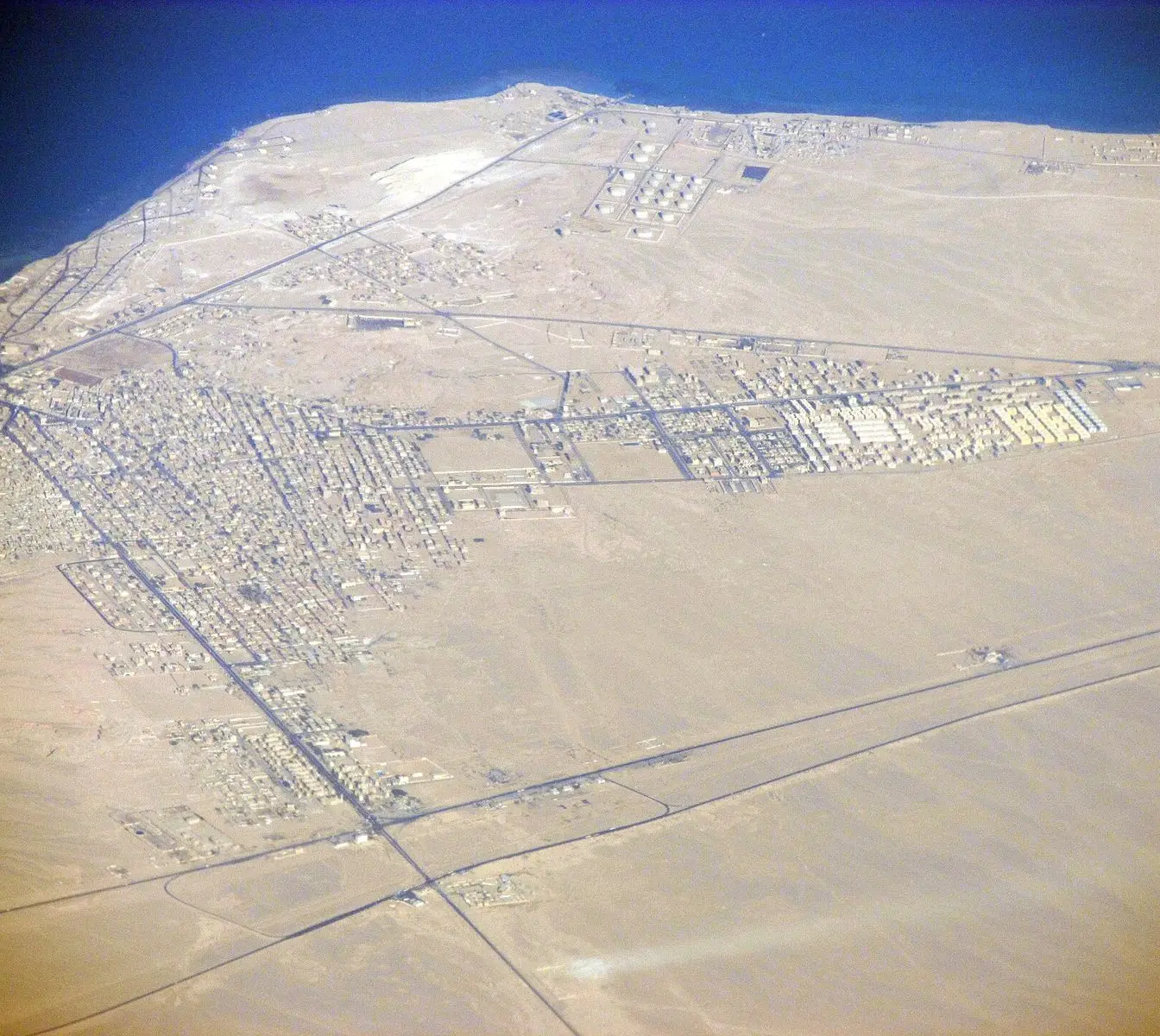 An aerial view of the town of Ras Ghareb on Egypt's Red Sea coast. The photograph is a general view of the town, not of the Al-Amal health unit.