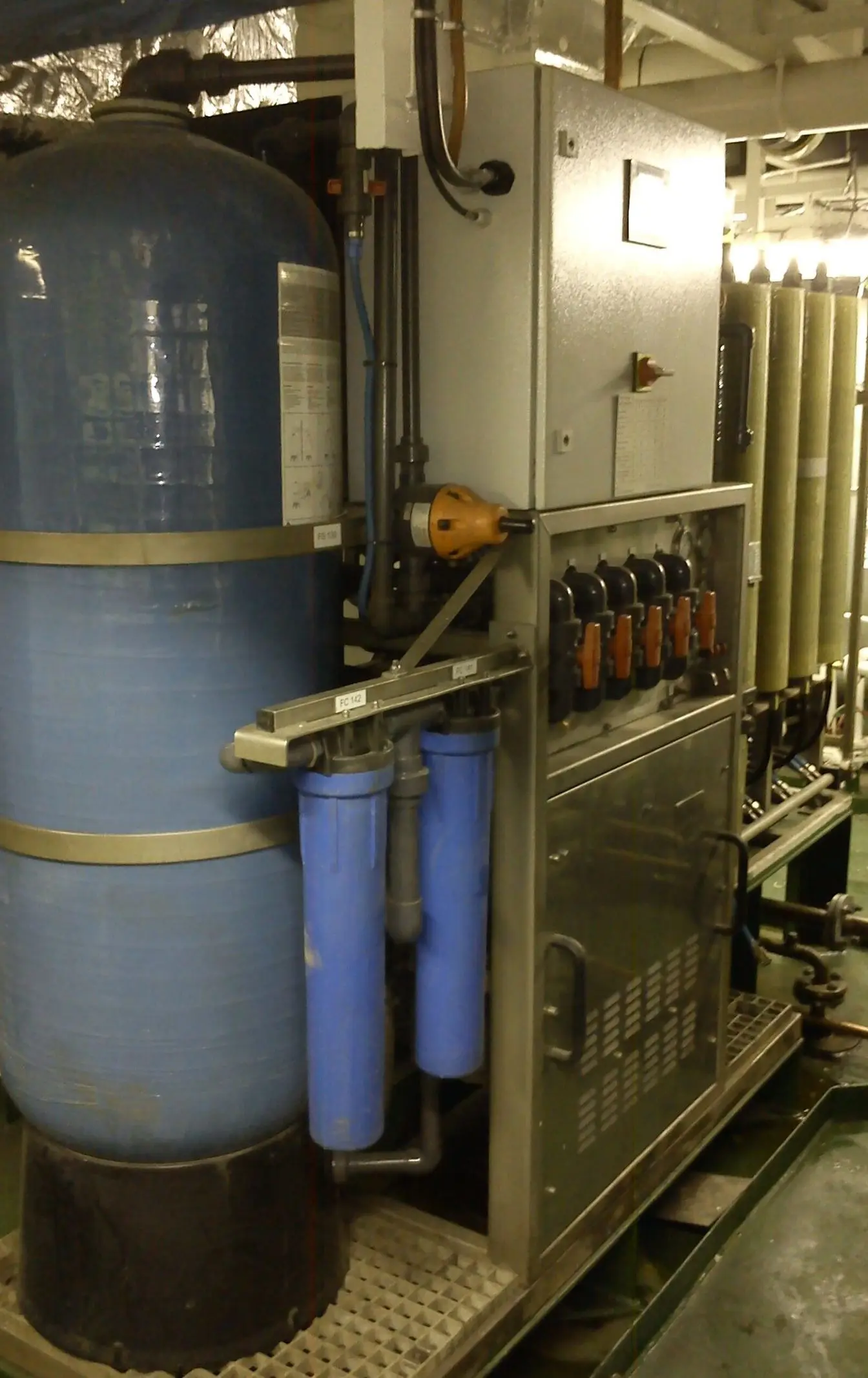 Rows of reverse-osmosis membrane pressure vessels inside a water treatment plant. Illustrative photograph of desalination equipment, not one of the Red Sea Governorate's plants.