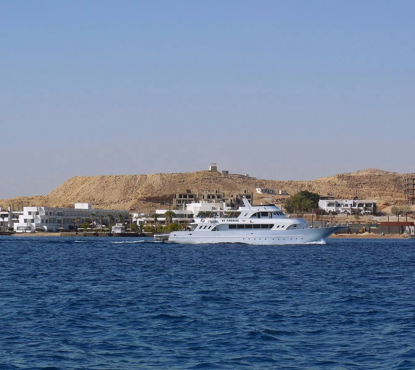 View of the Red Sea coastline from a boat trip near Hurghada, Egypt, with calm blue water