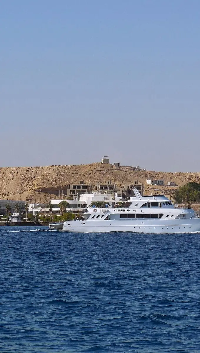View of the Red Sea coastline from a boat trip near Hurghada, Egypt, with calm blue water