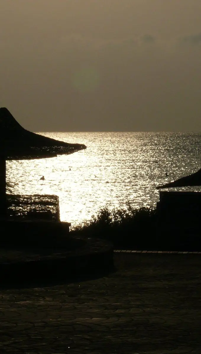Sunset over the Red Sea coast of Egypt, with warm light reflecting on calm water.