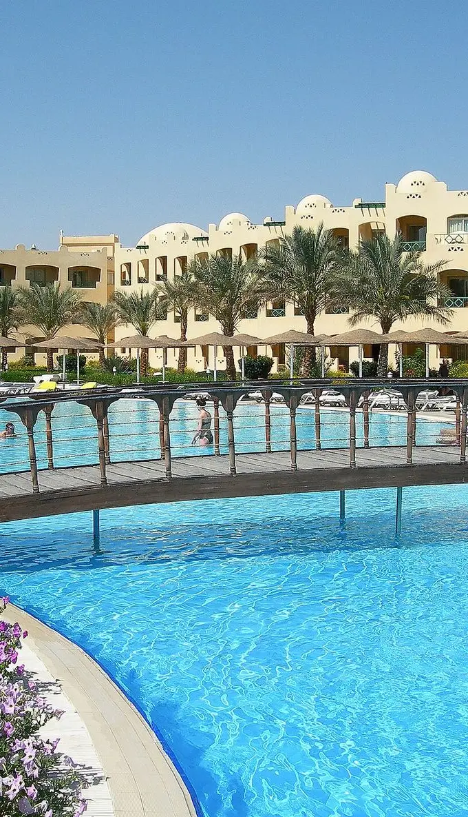 Resort hotel building at Makadi Bay near Hurghada, Egypt, with palm trees under a clear sky