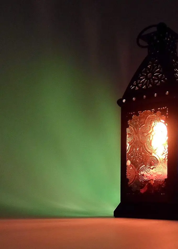 A traditional Egyptian Ramadan lantern (fanous) with ornate metal and colored glass panels