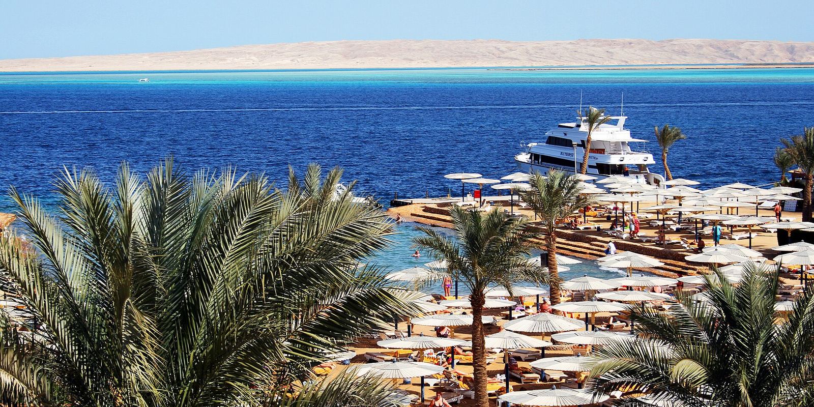 A hotel beach with a small marina and turquoise sea in Hurghada, Egypt