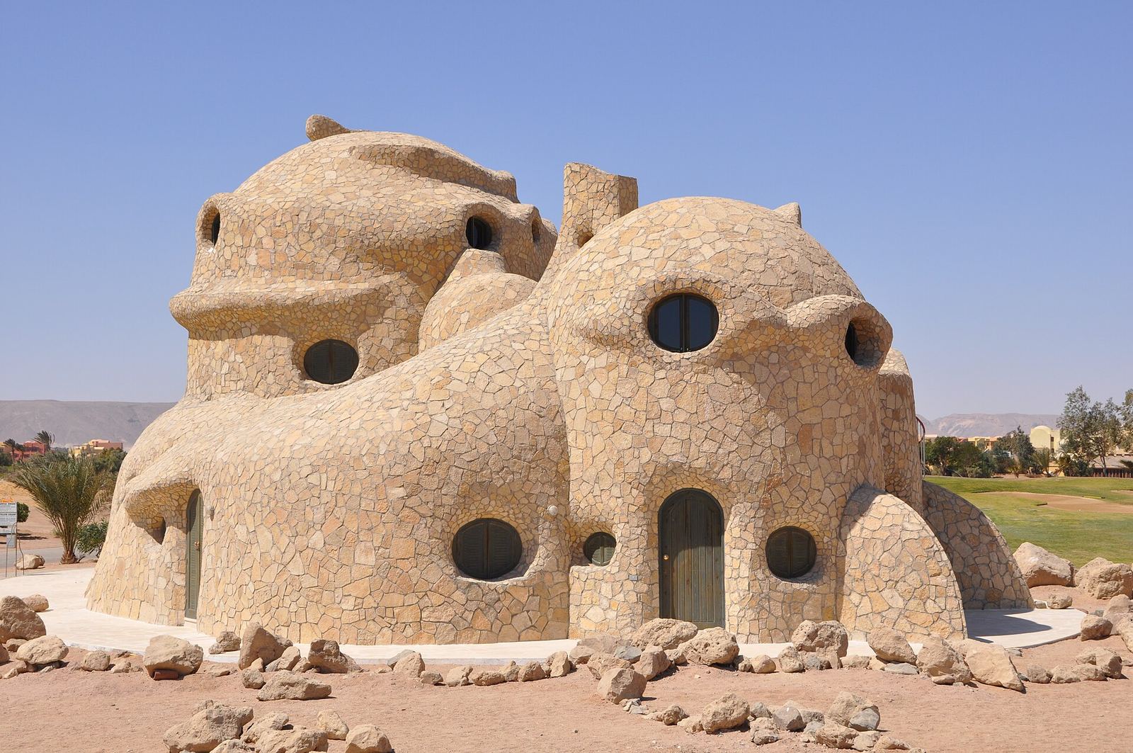 A distinctive waterside residential building in El Gouna, Egypt, known as the Turtle House, with architectural detailing along the water