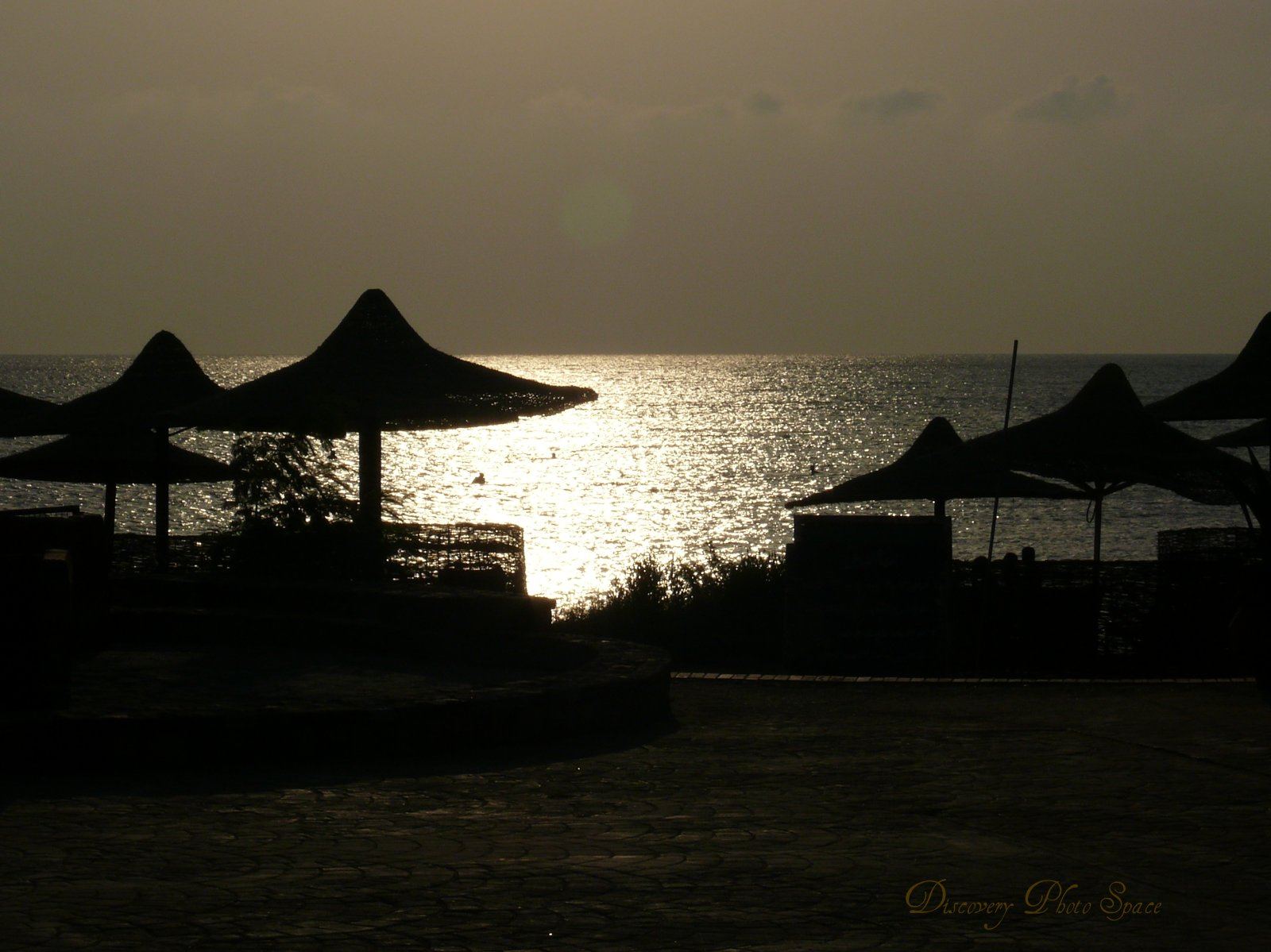 Sunset over the Red Sea coast of Egypt, with warm light reflecting on calm water.