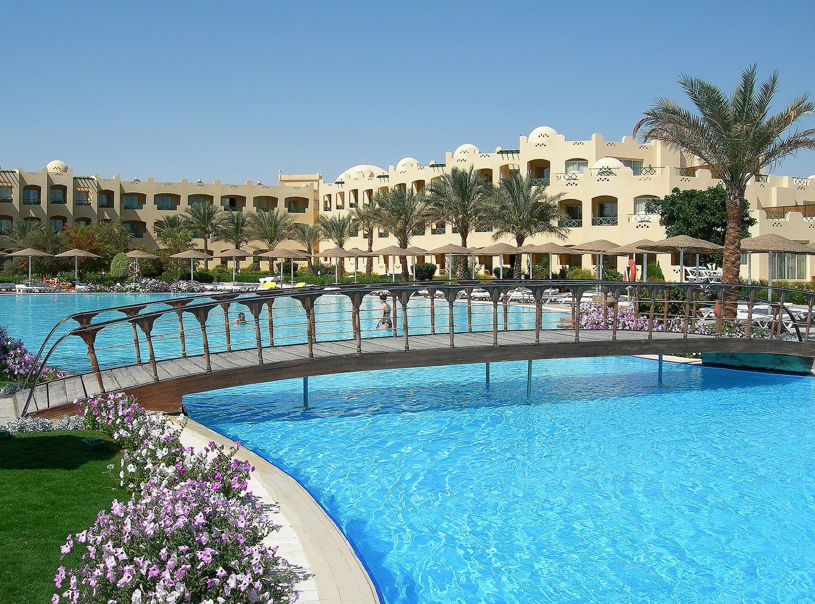 Resort hotel building at Makadi Bay near Hurghada, Egypt, with palm trees under a clear sky
