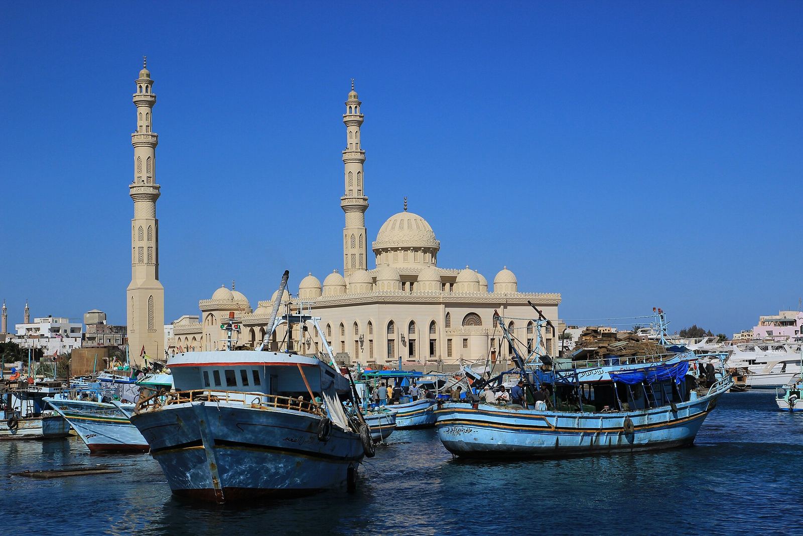A mosque at Hurghada port with domes and minarets under a clear sky