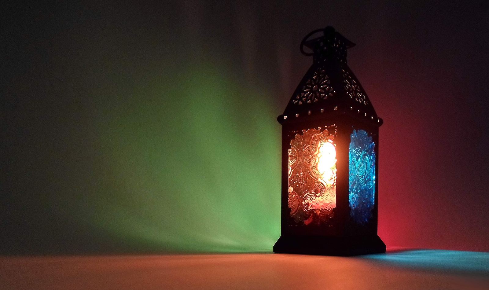 A traditional Egyptian Ramadan lantern (fanous) with ornate metal and colored glass panels