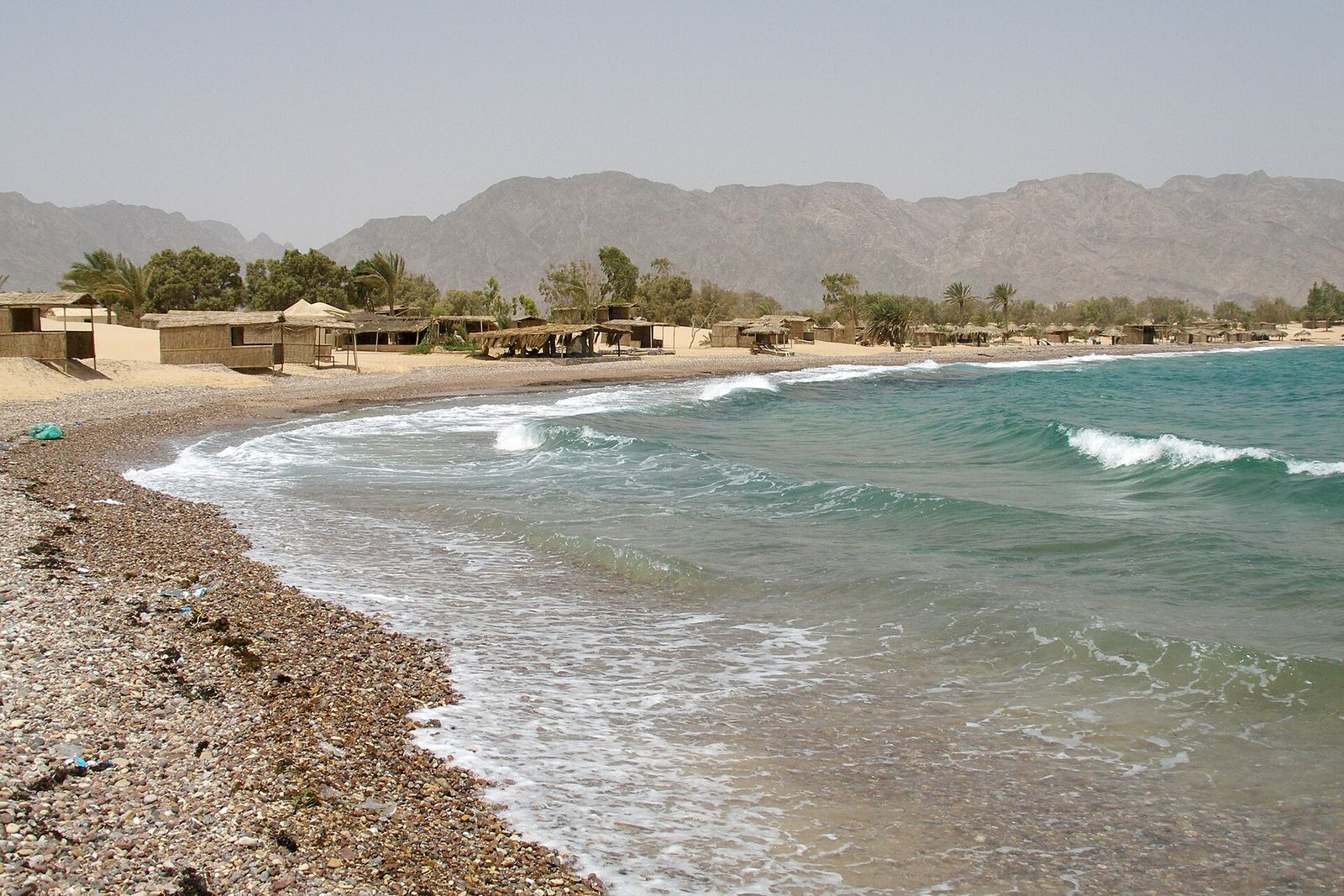 A quiet sandy beach on the Red Sea coast at Nuweiba, Sinai, Egypt, with calm blue water
