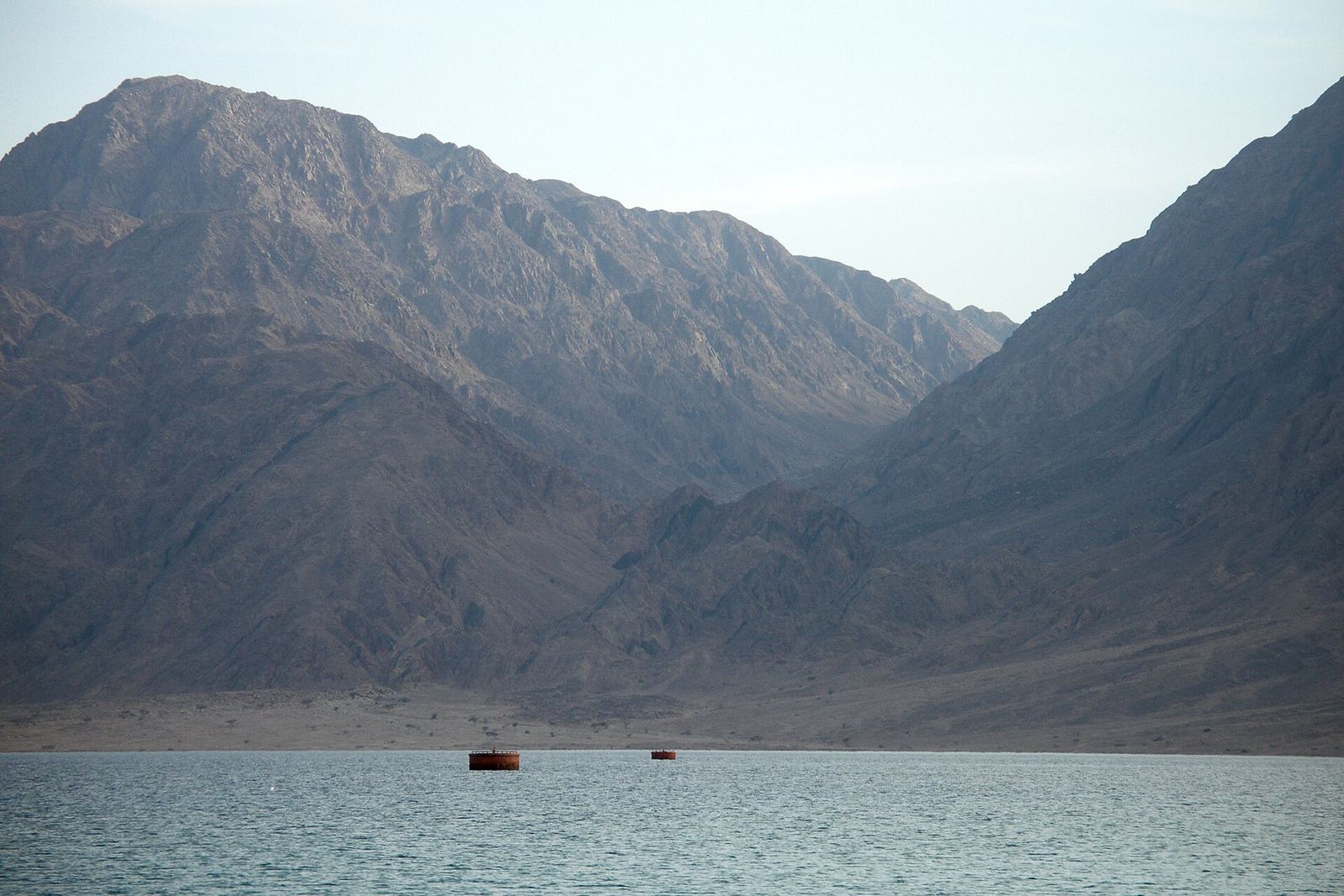 Rugged coastal mountains meeting the calm blue water of the Red Sea near Nuweiba, Sinai, Egypt.