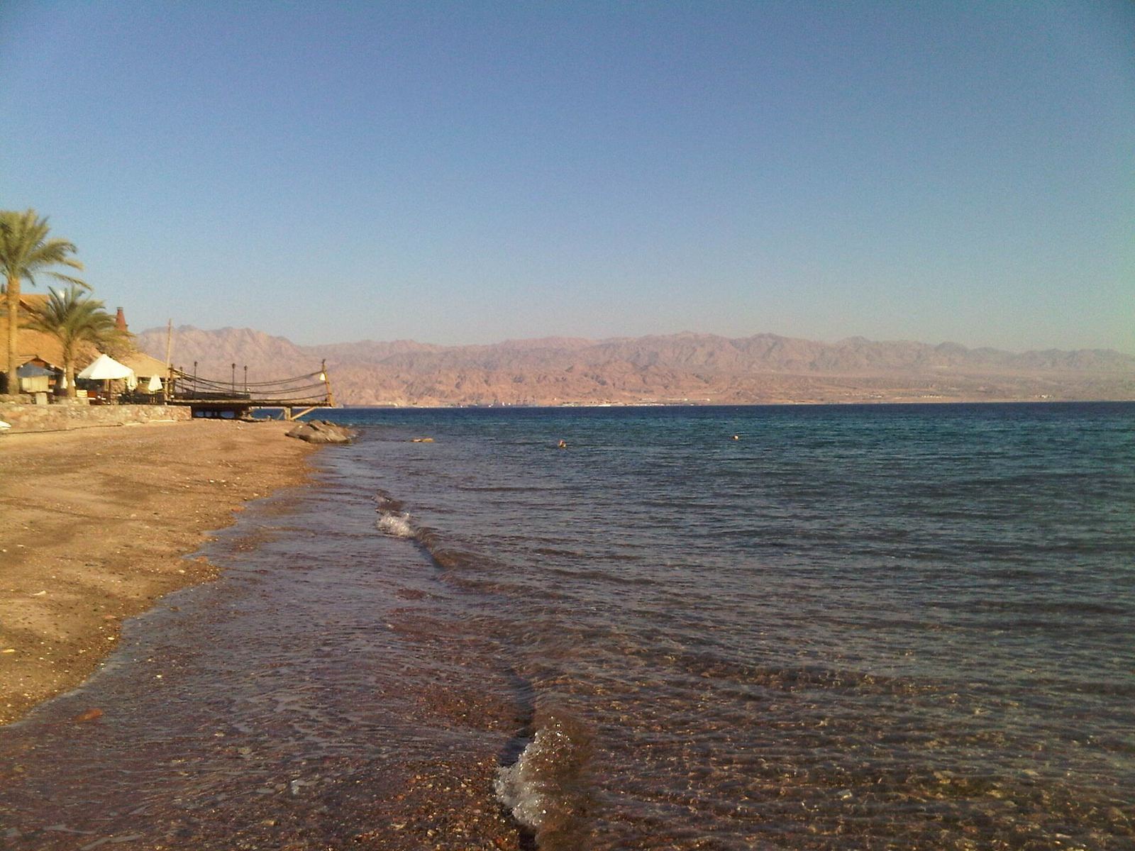 Stony beach along the Red Sea coast at Taba, Egypt, with calm blue water